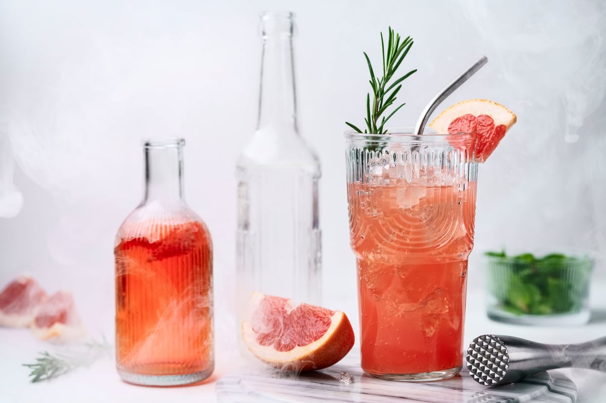 Grapefruit drink with ice and rosemary - artisan handmade soda